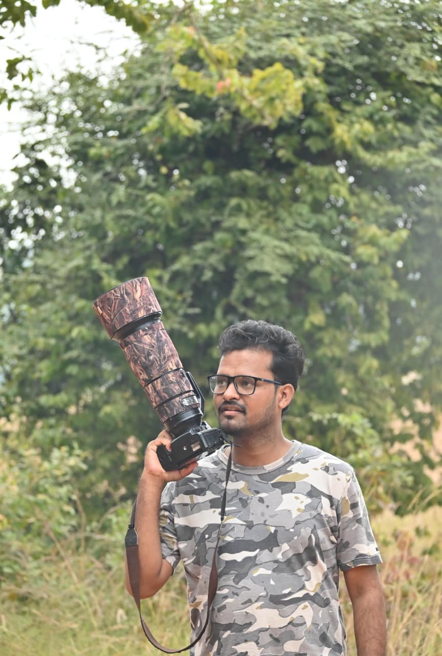 Wildlife photographer with a telephoto lens near Tadoba